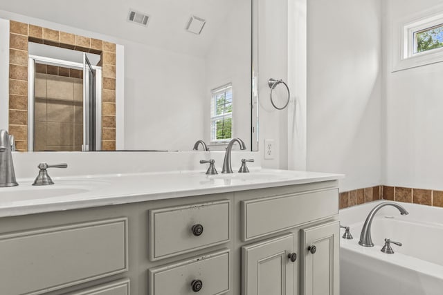 775 Markhams Dr, Madison, GA 30650 - full bath with plenty of natural light, double vanity, a bath, and tiled shower