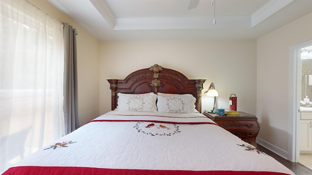 1190 Branch Creek Way, Greensboro, GA 30642 - bedroom with connected bathroom, a tray ceiling, wood-type flooring, and ornamental molding