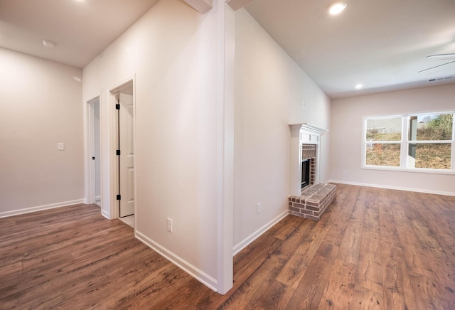 unfurnished living room with dark hardwood / wood-style flooring and a fireplace