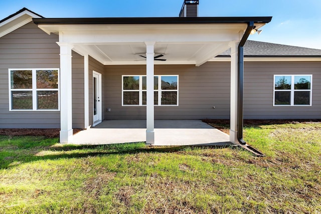 back of house featuring a yard, a patio area, and ceiling fan