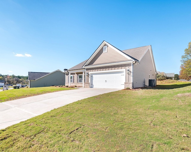 view of front of house with a garage, a front yard, and central air condition unit