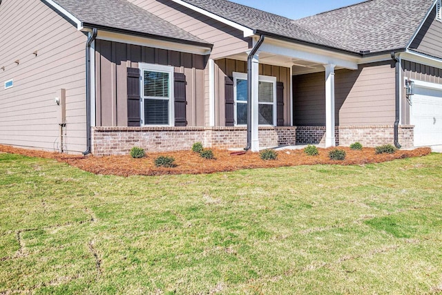 view of side of home featuring a yard and a garage