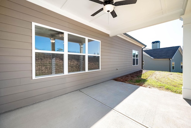 view of side of property featuring ceiling fan and a patio