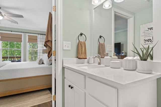 bathroom with wood finished floors, ensuite bath, vanity, and crown molding