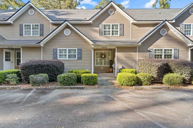 view of property featuring a shingled roof