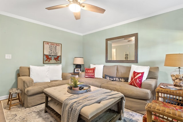 living area featuring ceiling fan, baseboards, and crown molding