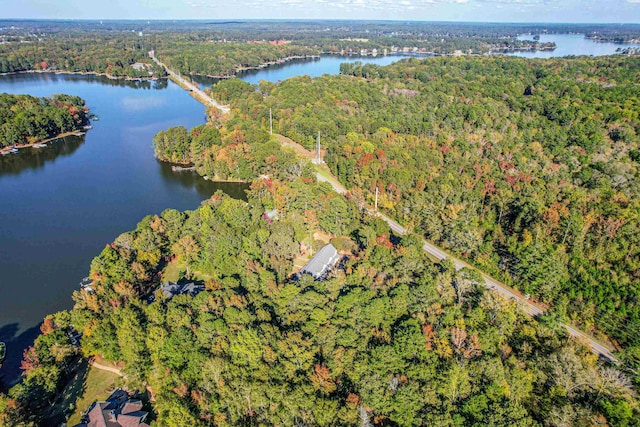 bird's eye view with a water view and a forest view