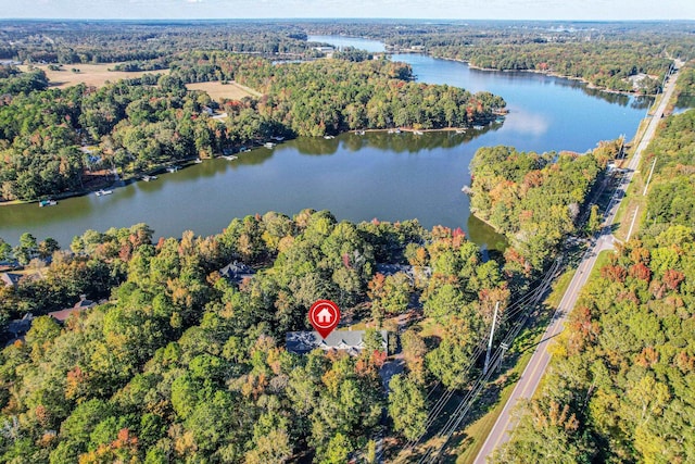 aerial view with a water view and a forest view