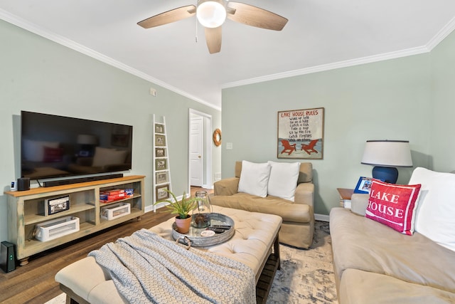 living room with baseboards, ornamental molding, ceiling fan, and wood finished floors