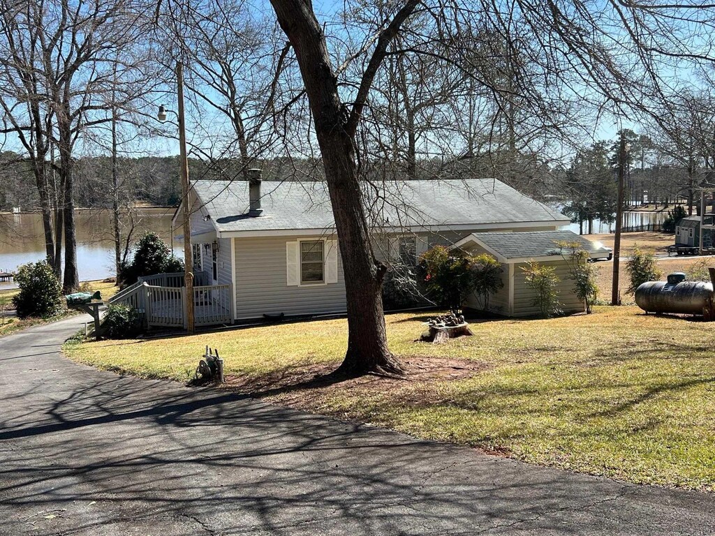 168 Oak Ln, Eatonton, GA 31024 - view of front facade with a front lawn and a water view