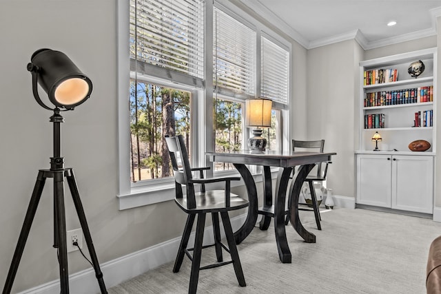 dining area featuring built in features, ornamental molding, and light carpet