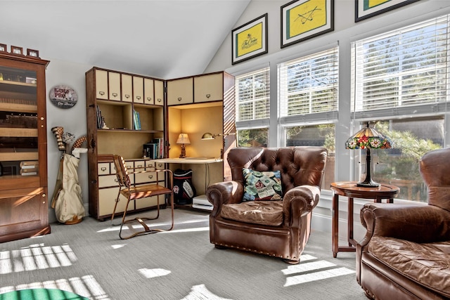 living area with lofted ceiling and light carpet