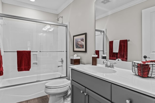 full bathroom with enclosed tub / shower combo, ornamental molding, toilet, and vanity