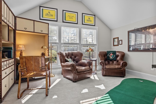 sitting room with light carpet and high vaulted ceiling