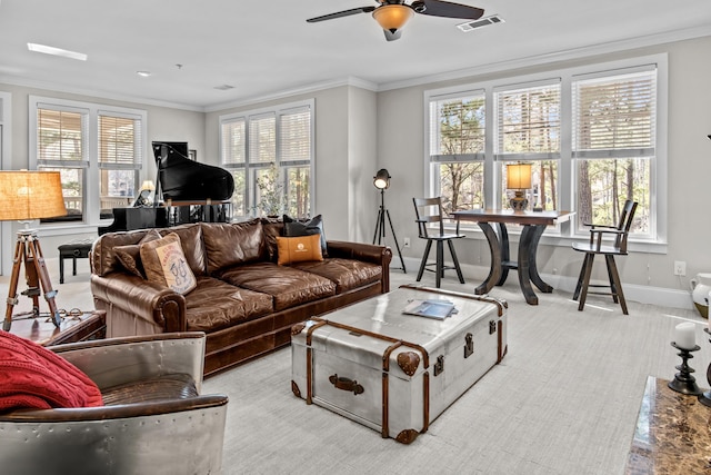 living room with ceiling fan and ornamental molding