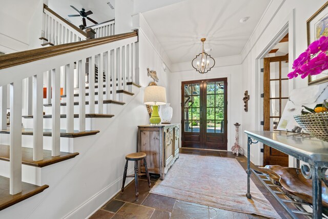 112 Arbors Ln, Eatonton, GA 31024 - entrance foyer featuring ceiling fan with notable chandelier, french doors, stone tile flooring, and stairs