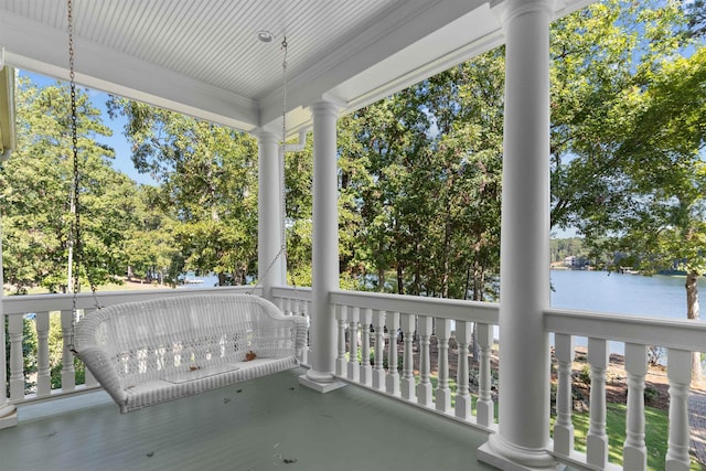 unfurnished sunroom with a water view