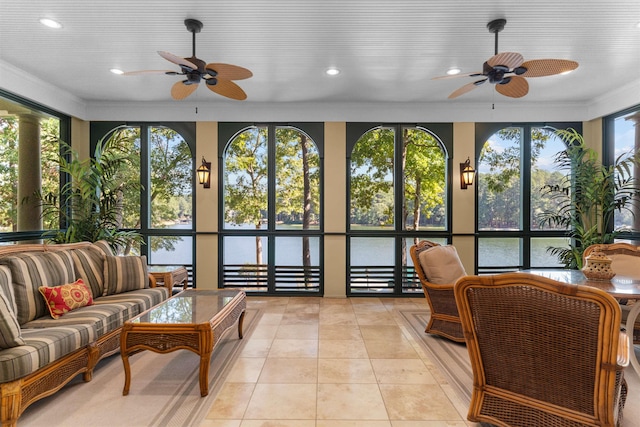 sunroom / solarium featuring ceiling fan