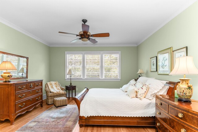 bedroom with ceiling fan, ornamental molding, and light hardwood / wood-style flooring