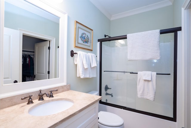 full bathroom with vanity, crown molding, toilet, and combined bath / shower with glass door