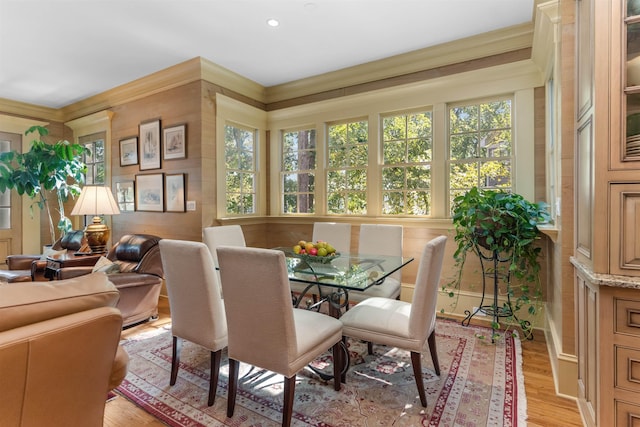 dining room featuring crown molding and light wood-type flooring