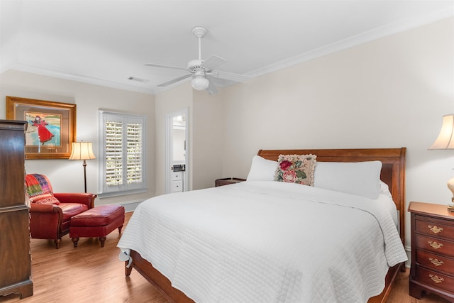 bedroom featuring hardwood / wood-style flooring, ceiling fan, and ornamental molding