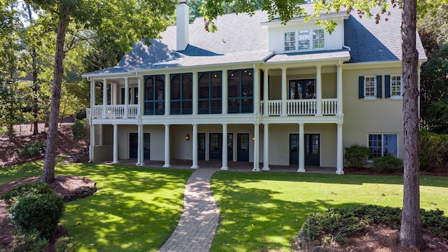 view of front of house featuring a patio and a front lawn