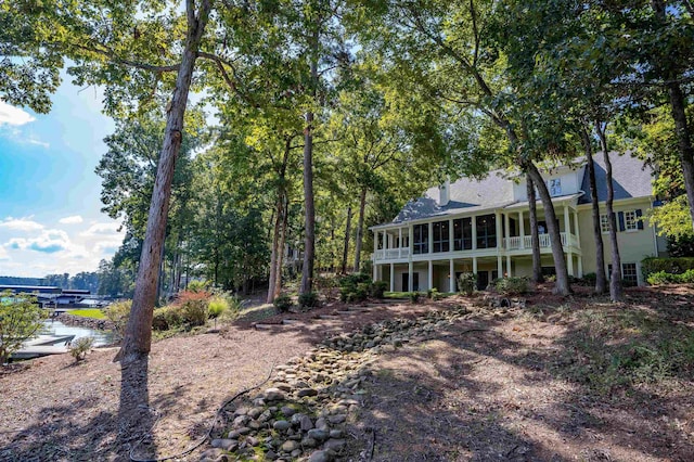 rear view of property with a sunroom