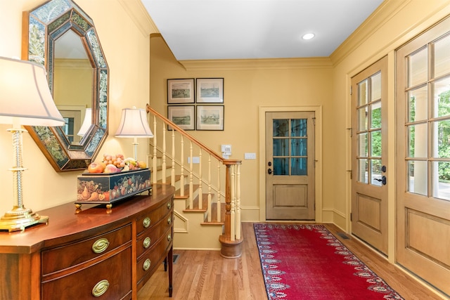 entryway featuring crown molding and hardwood / wood-style flooring