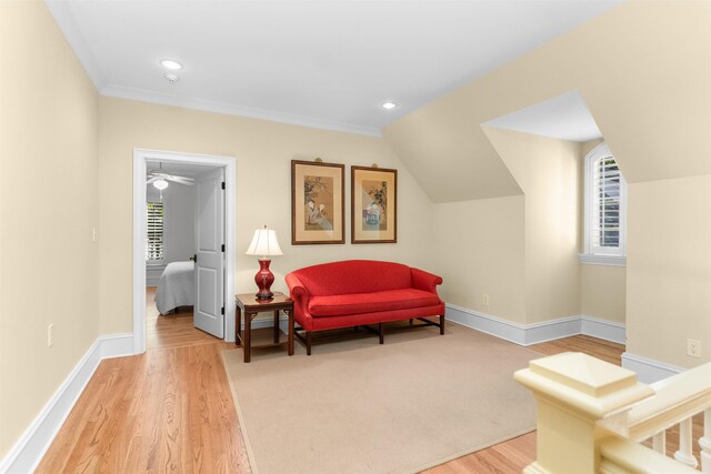 living area featuring light hardwood / wood-style flooring, a healthy amount of sunlight, and vaulted ceiling