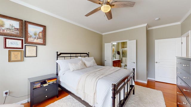 bedroom with wood-type flooring, ornamental molding, ceiling fan, and ensuite bath