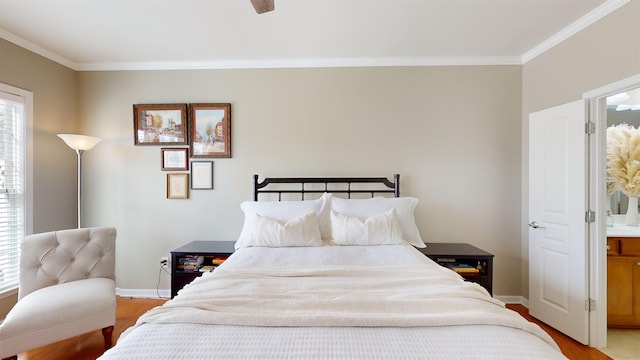 bedroom with ornamental molding, connected bathroom, and light hardwood / wood-style flooring