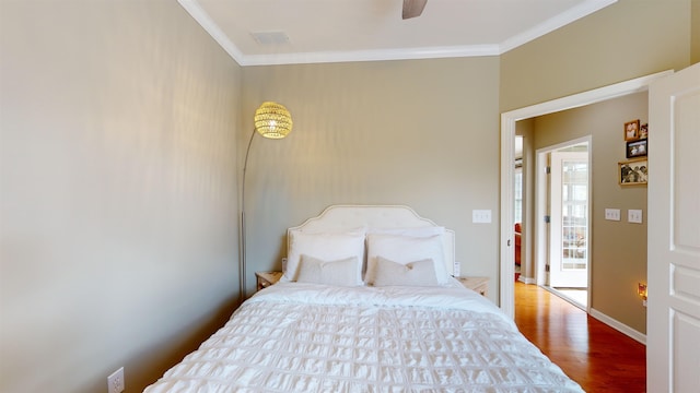 bedroom with hardwood / wood-style flooring and ornamental molding