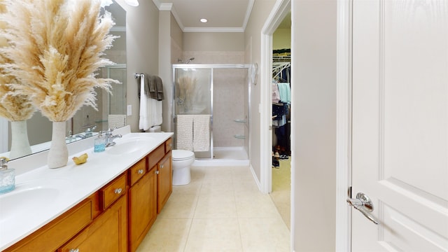 bathroom with crown molding, tile patterned floors, a shower with shower door, and vanity