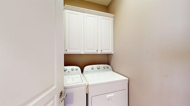 laundry room featuring cabinets and independent washer and dryer