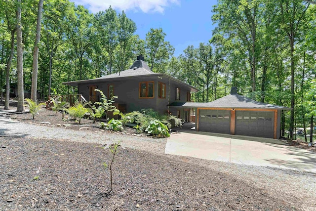 114 Oak Ridge Ln, Eatonton, GA 31024 - view of front of home featuring a chimney, driveway, and an attached garage