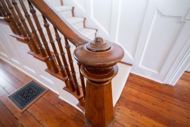 1011 Dogwood Dr, Greensboro, GA 30642 - stairway with visible vents and wood-type flooring