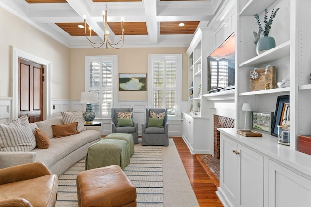 1011 Dogwood Dr, Greensboro, GA 30642 - living area with an inviting chandelier, dark wood-style floors, crown molding, beam ceiling, and coffered ceiling
