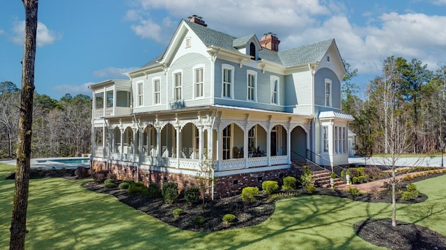 1011 Dogwood Dr, Greensboro, GA 30642 - view of home's exterior featuring a yard, a sunroom, and a chimney