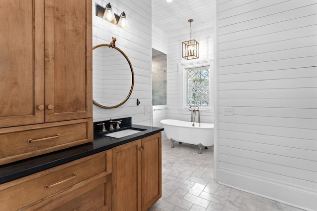 1011 Dogwood Dr, Greensboro, GA 30642 - full bath featuring wood walls, vanity, an inviting chandelier, and a soaking tub