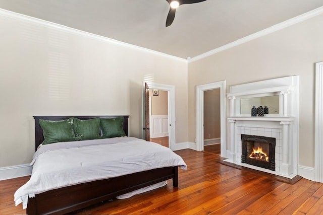 1011 Dogwood Dr, Greensboro, GA 30642 - bedroom featuring baseboards, a fireplace, crown molding, ceiling fan, and hardwood / wood-style flooring