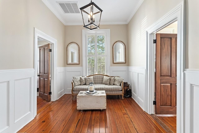 1011 Dogwood Dr, Greensboro, GA 30642 - living area featuring wainscoting, visible vents, crown molding, and dark wood-style floors