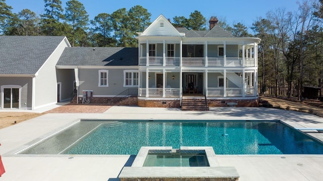 1011 Dogwood Dr, Greensboro, GA 30642 - back of property with a patio area, a pool with connected hot tub, a balcony, and a chimney