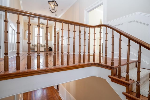 1011 Dogwood Dr, Greensboro, GA 30642 - stairway featuring crown molding and wood finished floors