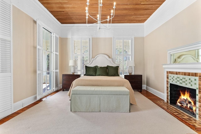 1011 Dogwood Dr, Greensboro, GA 30642 - bedroom with a tiled fireplace, wood ceiling, crown molding, and wood finished floors