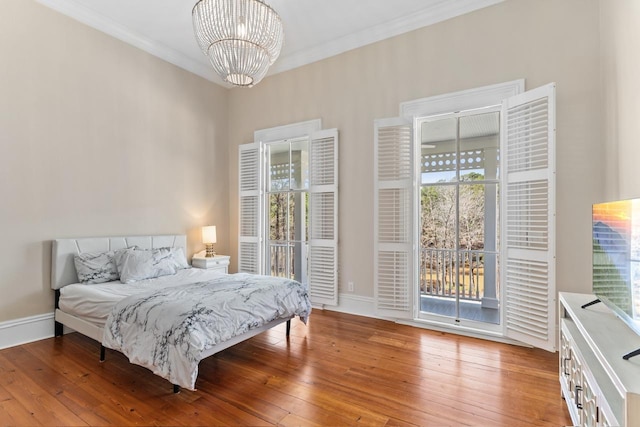 1011 Dogwood Dr, Greensboro, GA 30642 - bedroom with hardwood / wood-style floors, access to exterior, an inviting chandelier, and ornamental molding