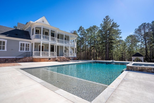 1011 Dogwood Dr, Greensboro, GA 30642 - view of swimming pool featuring a pool with connected hot tub, a patio area, and covered porch