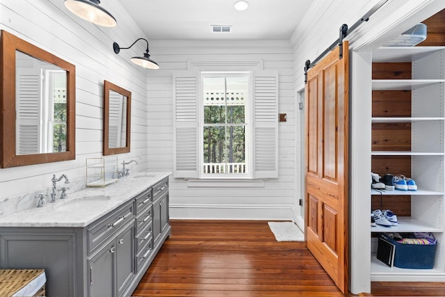 1011 Dogwood Dr, Greensboro, GA 30642 - bathroom with a sink, visible vents, double vanity, and hardwood / wood-style floors