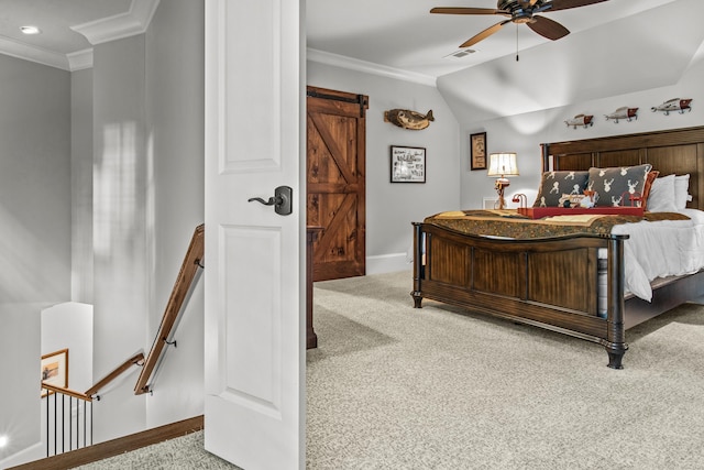 carpeted bedroom with vaulted ceiling, ornamental molding, a barn door, and ceiling fan