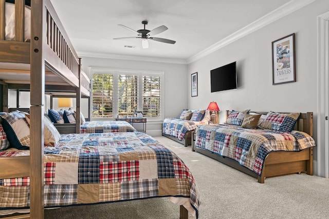 bedroom with ornamental molding, ceiling fan, and carpet